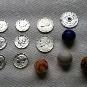 Silvers and marbles found at old school house.