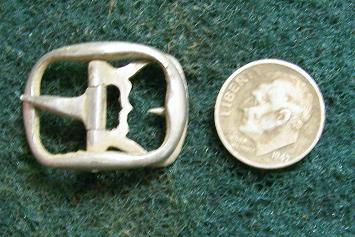 1690-1720 solid silver shoe buckle next to rosie