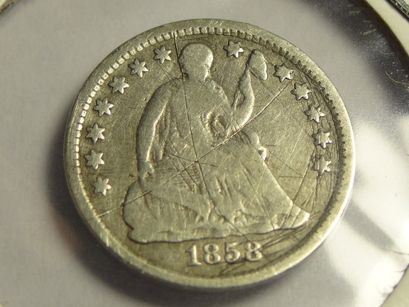 1858 half dime shaved smooth on reverse.  Possibly start of a Love Token?