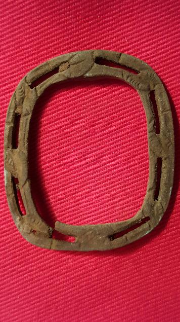 An "open work" styled  knee buckle frame , along the frame are leaf motif stamping .