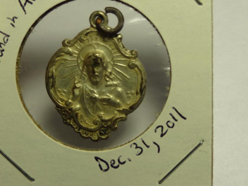 One of 4 religious medals found in same hole.