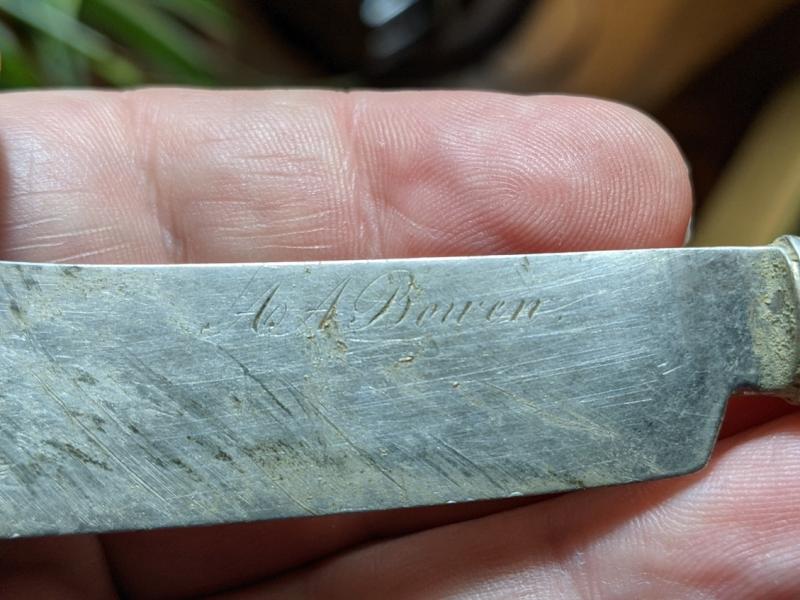 Silver butter knife with the name of the man who murdered his wife in the early 1900s. Found where his house used to stand.